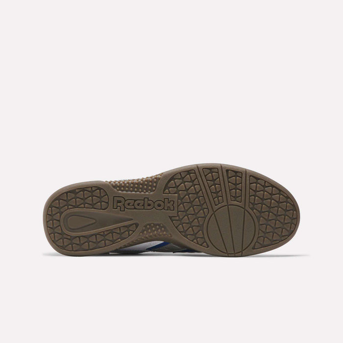 The brown rubber sole of the Reebok Hammer Valde Shoes features textured grip patterns and an embossed Reebok logo at the center. The durable leather upper is visible as the shoe is laid flat with its sole facing upward against a plain background.