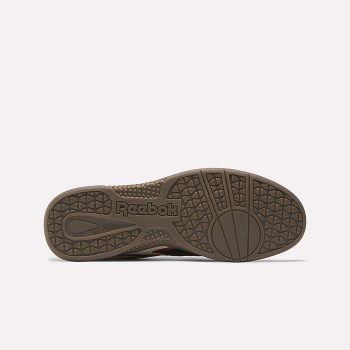 The image shows the brown outsole of Reebok Hammer Valde Shoes from the bottom, featuring textured grip patterns, circular designs, and the embossed Reebok logo near the heel, complementing its classic leather upper.