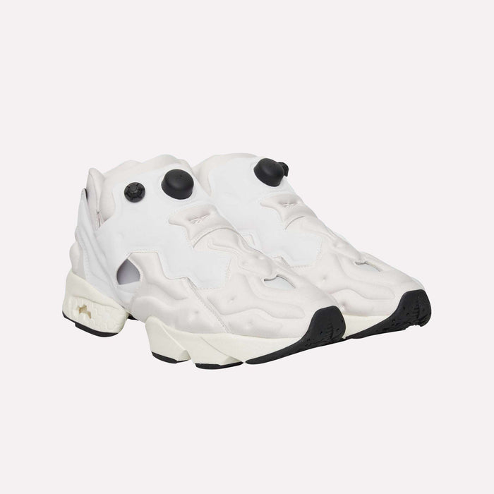 A pair of Reebok Instapump Sliver LTD Shoes, modern white sneakers with chunky soles, black toe tips, and black circular accents on the top—featuring innovative Hexalite cushioning for superior comfort—displayed on a plain white background.