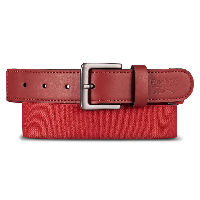 A Reebok Youth Baseball Belt in red with a silver buckle is shown atop a red box, featuring the Reebok logo near the end and an adjustable design for a secure fit.
