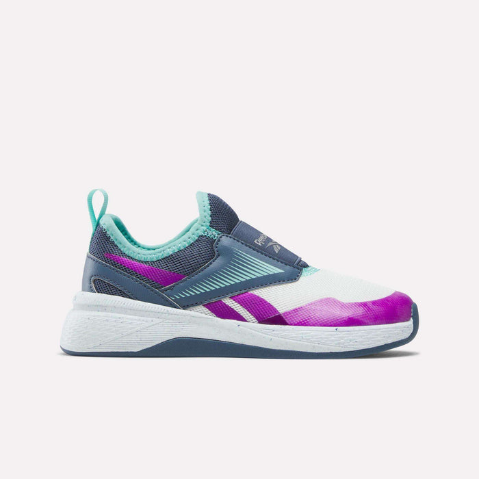 The Kids' Nano Play Slip-on by Reebok is a colorful girls’ training shoe featuring a white sole, teal and navy upper, teal heel loop, and purple accents—shown in side view against a plain white background.