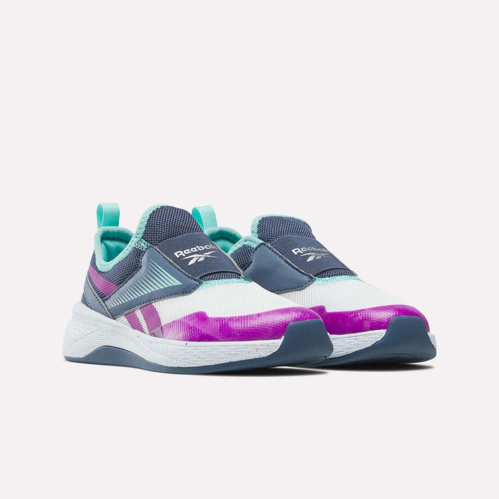 Reebok Kids' Nano Play Slip-on girls training shoes feature a blue, teal, white, and purple color scheme with mesh uppers and a white sole accented in blue and teal.