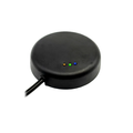 A black circular electronic device with a power cable extending from the side and three small indicator LEDs