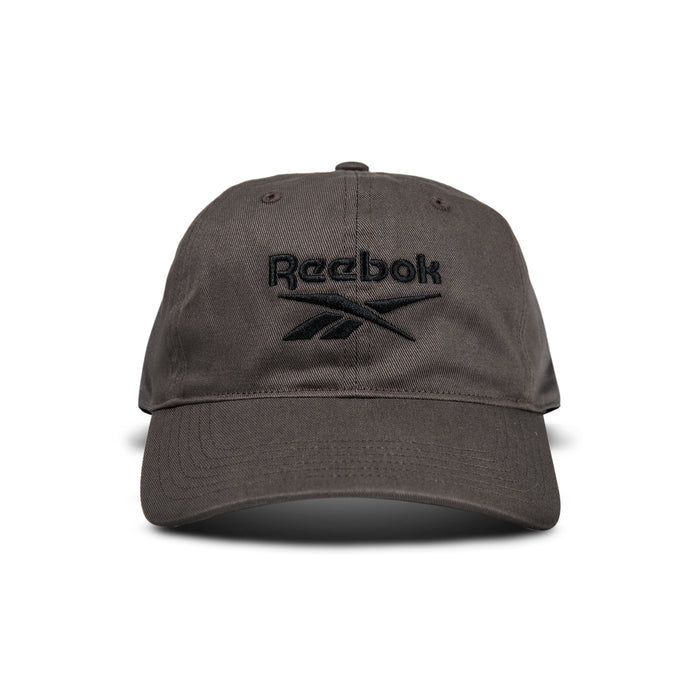 A dark gray Reebok Logo Cap with a black embroidered logo and text on the front is displayed from the front against a white background.