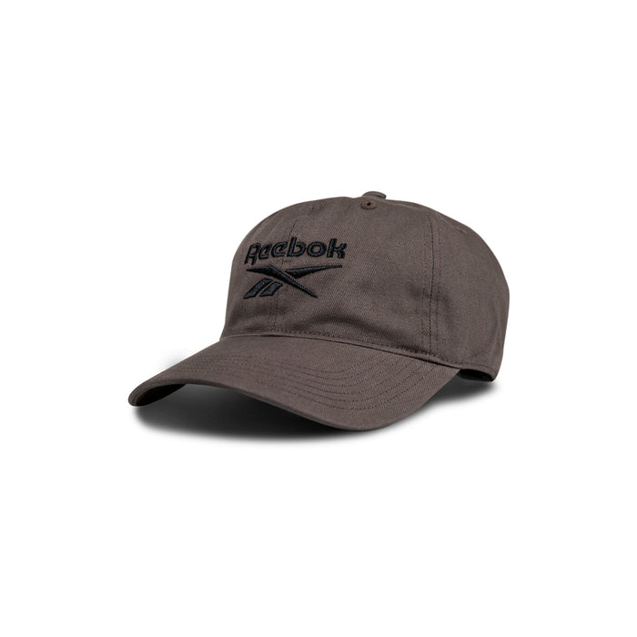 The Reebok Logo Cap is a dark gray baseball cap featuring a curved brim and black embroidered logo on the front, displayed against a white background.