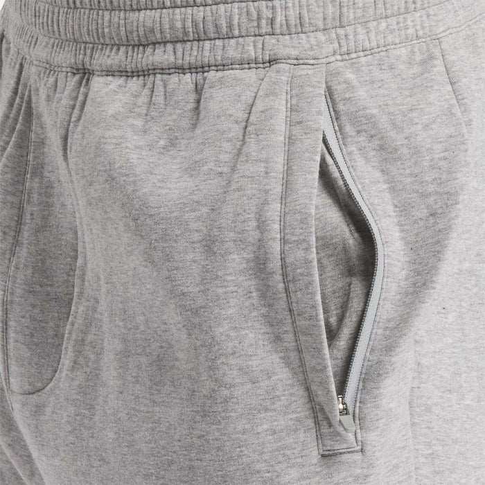 Close-up of Reebok Men's Active Collective DreamBlend Pants in light gray, showcasing an elastic waistband and two pockets (one zippered). Made from soft DreamBlend fabric, these tapered pants deliver both comfort and style.