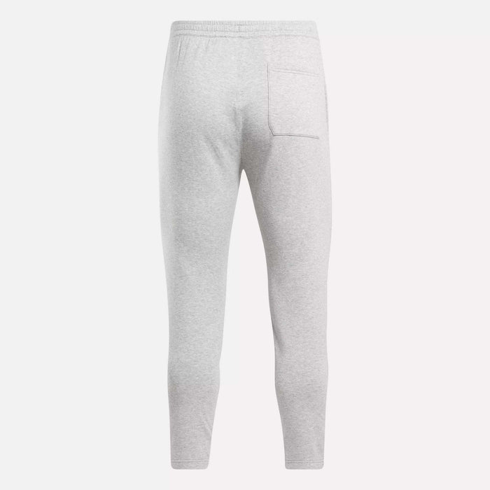 Back view of Reebok Men's Active Collective DreamBlend Pants in light gray, featuring an elastic waistband and a right-side patch pocket, made from soft DreamBlend fabric for comfort.