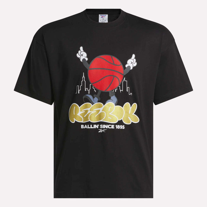 Reebok Men's Basketball T-Shirt—black cotton tee with a cartoon character holding a red basketball, city skyline background, and bold "Reebok Ballin Since 1895" text. Perfect for basketball fans.