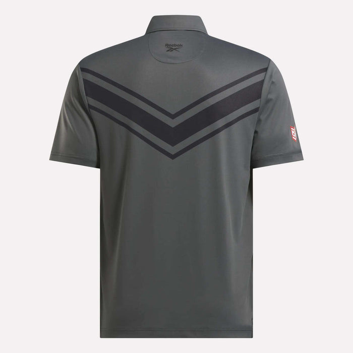 A gray Reebok Men's BDC Colorblocked Polo Shirt seen from the back features RBK-DRY tech, two dark chevron stripes on the upper back, the Reebok logo below the collar, and a small red patch on the left sleeve.