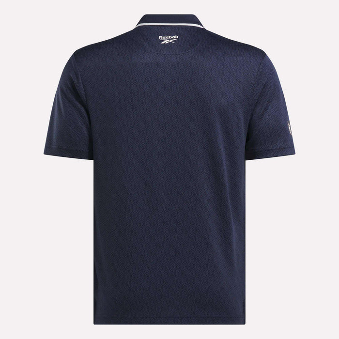 Back view of the Men's BDC Signature Polo Shirt by Reebok in navy blue, featuring RBK-DRY fabric, a subtle textured pattern, a collar, and the Reebok logo below the neckline.