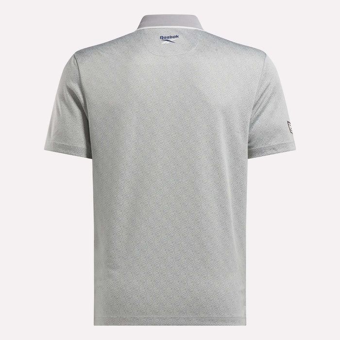 Back view of the Men's BDC Signature Polo Shirt by Reebok in light gray, featuring short sleeves, a subtle geometric pattern, and logos near the collar and left sleeve. Made with RBK-DRY fabric for comfort on and off the course.