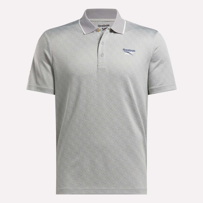 The Reebok Men's BDC Signature Polo Shirt features a light gray color, subtle pattern, short sleeves, moisture-wicking RBK-DRY fabric, a three-button placket, Reebok logo on the left chest, and dark trim on the collar and sleeves.