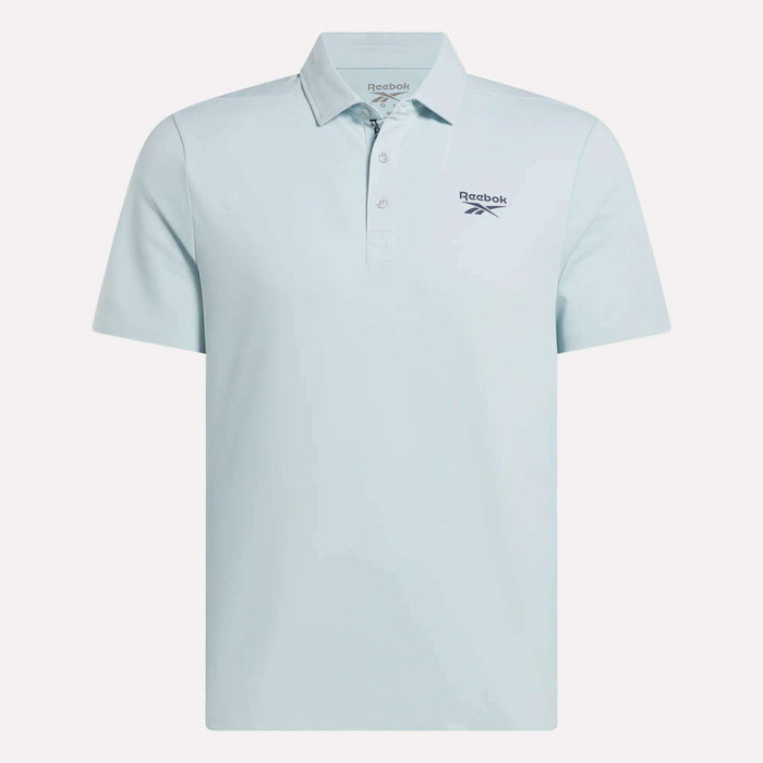 The Reebok Men's Bonded Pique Polo Shirt is light blue with short sleeves, a collar, and buttons. An embroidered Reebok logo decorates the left chest. Shown on a plain white background.