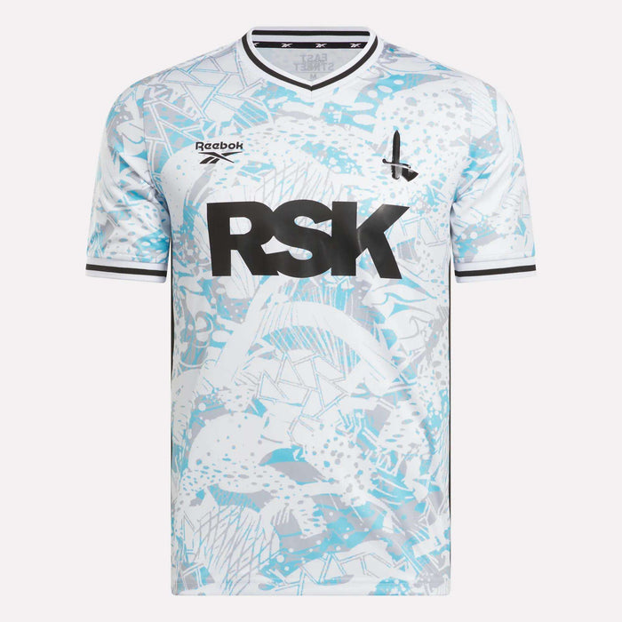 The Men's Charlton Away Jersey by Reebok features a white and light blue fish scale pattern, black trim, bold RSK lettering, a small rocket ship graphic, and Addicks pride.