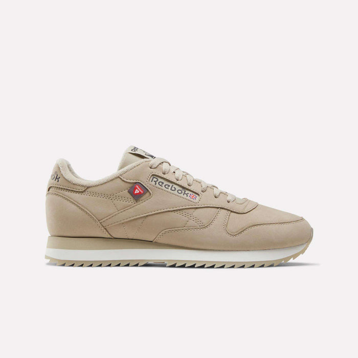The Men’s Classic Leather Ripple Shoes by Reebok are featured in Elevated Beige/Almost Black/Chalk, showcasing a gum sole, EVA midsole, and lace-up design in a side profile view against a plain white background.