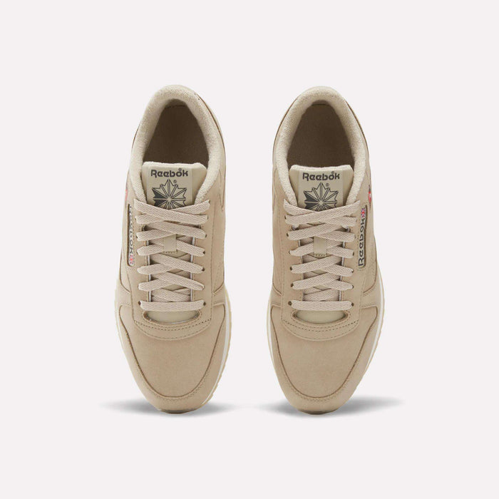 A pair of Men’s Classic Leather Ripple Shoes by Reebok in beige is seen from above, highlighting the laces, branded tongues, and subtle stitching details against a plain white background.