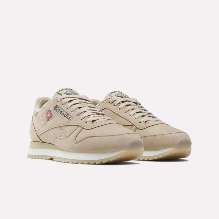 A pair of Men’s Classic Leather Ripple Shoes by Reebok in beige, featuring white EVA midsoles, beige laces, and red and gray Reebok logos on the sides and tongues, displayed on a white background.
