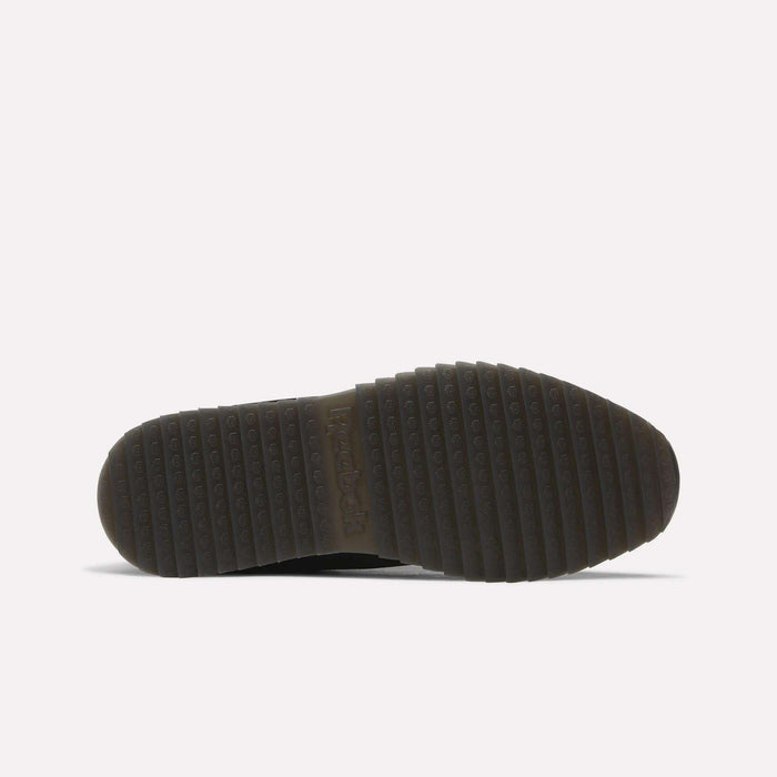 The image shows the textured black rubber outsole of the Reebok Men’s Classic Leather Ripple Shoes, viewed from the bottom against a white background. The sole features horizontal grooves and small circular bumps for traction, paired with an EVA midsole for enhanced comfort and support.