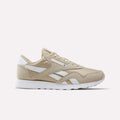Elevated Beige and white Men’s Classic Nylon Shoes by Reebok, featuring a white sole, classic white side stripes, and a small Union Jack logo near the laces—timeless men’s sneakers inspired by retro styles, shown on a plain white background.