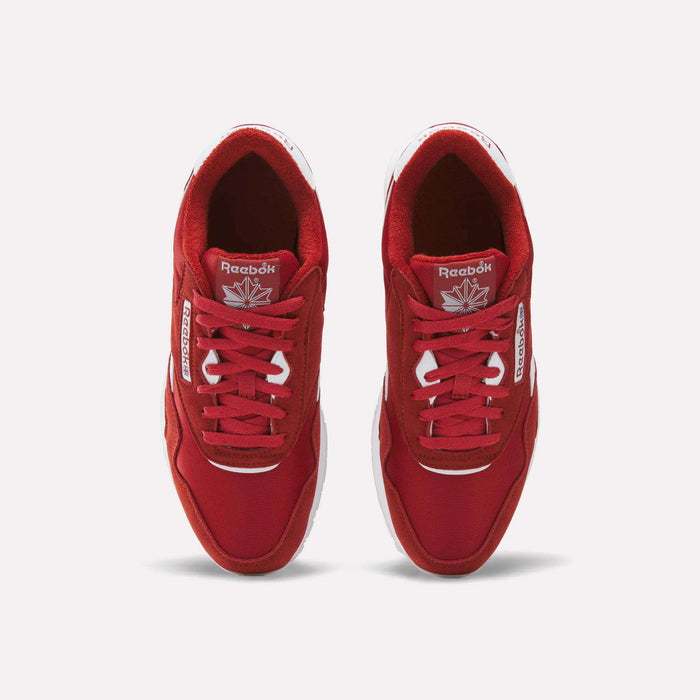 Top view of a pair of Reebok Men’s Classic Nylon Shoes in red, featuring white soles and white Reebok branding on the sides and tongue, placed side by side on a white background for an effortlessly timeless retro vibe.