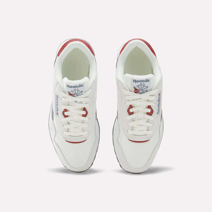 A pair of Reebok Men’s Classic Nylon Shoes in white with red accents, made from mixed materials and shown from above, featuring the signature Reebok logo on both the tongue and side. These sneakers are designed with a supportive EVA midsole for enhanced comfort.