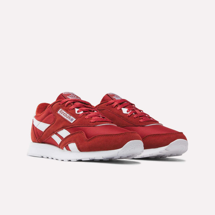 A pair of Reebok Men’s Classic Nylon Shoes in red with white accents and white soles, presented against a plain white background.