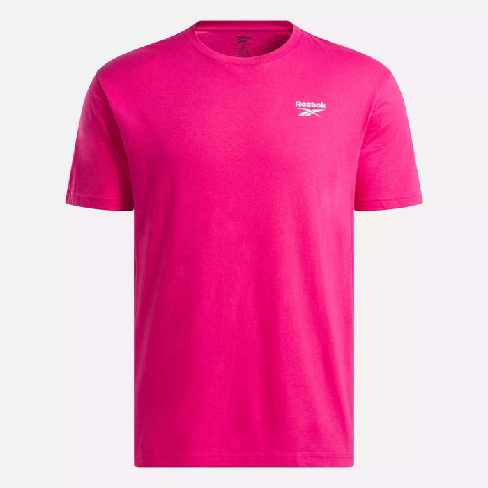 The Reebok Men's Classic Small Logo T-Shirt is bright pink, made of soft cotton with a crew neck and a small white logo on the left chest, shown on a plain white background.
