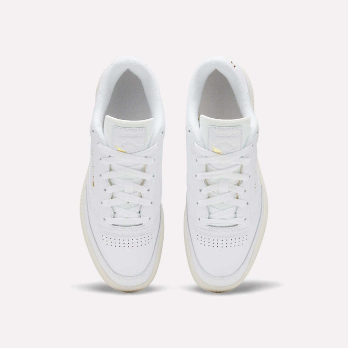 The Reebok Men's Club C 85 Shoes, crafted from premium white garment leather with white laces and subtle toe perforations, showcase the timeless style of a classic sneaker against a light background.