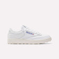 The Men's Club C Golf Shoes by Reebok are white, low-top sneakers with the Reebok logo and Union Jack on the side, water-resistant leather, white laces, and a textured off-white spikeless outsole, shown against a plain light background.