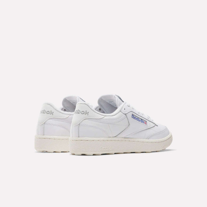 Men's Club C Golf Shoes by Reebok in white with off-white soles, water-resistant leather, and blue and red logo accents, displayed from side and back views on a plain white background.