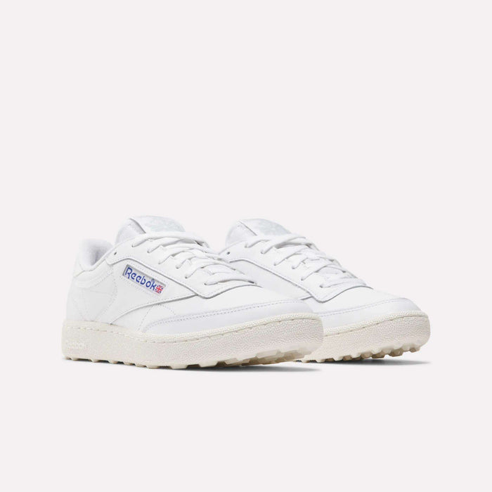 The Reebok Men's Club C Golf Shoes in white feature off-white spikeless soles, a classic low-top design, and the signature side Reebok logo, shown on a plain white background.