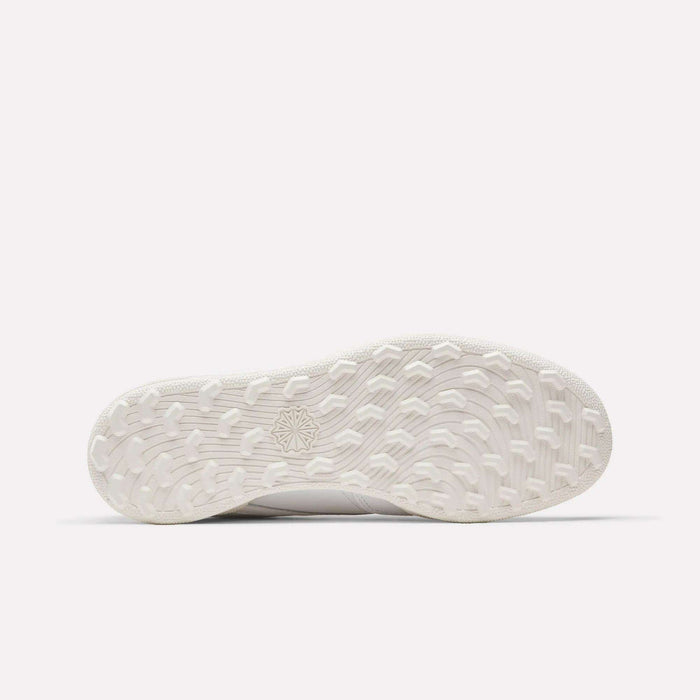 The Men's Club C Golf Shoes by Reebok feature a white rubber spikeless outsole with textured grip and a center starburst design, shown here against a plain white background.