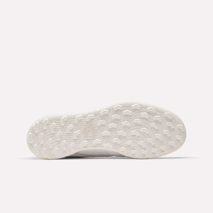 The Men's Club C Golf Shoes by Reebok feature a white rubber spikeless outsole with textured grip and a center starburst design, shown here against a plain white background.