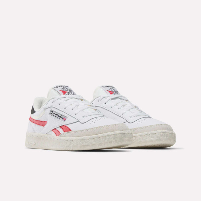 The Reebok Men's Club C Revenge Shoes in white premium leather feature pink and gray accents and display the Reebok logo on the side and tongue, shown against a plain white background.