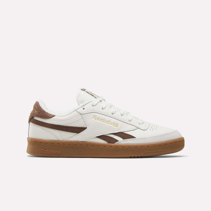 The Reebok Men's Club C Revenge Vintage Shoes in Chalk/Formalbrown/Gum feature brown suede accents, gold Reebok logos, and a brown gum sole, shown in side profile on a white background. Classic leather sneakers with vintage appeal.