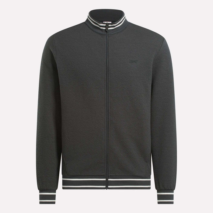 The Men's Club Sport Textured Jacket by Reebok is a black thermal knit jacket with a sporty, minimalist design and features white and black striped ribbed collar, cuffs, and waistband. No visible logos or patterns for a clean look.