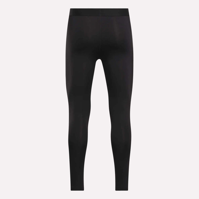 The Reebok Men's Core Training Tights are black, full-length, and fitted, shown front-facing on a plain white background with no visible logos or designs. These sweat-wicking leggings are ideal for intense workouts.
