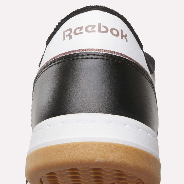 Close-up of the back of the Reebok Men’s Court LXS Shoes in black and white with a gum sole, made from full grain leather and featuring the Reebok logo on the heel—a perfect men’s court shoe.