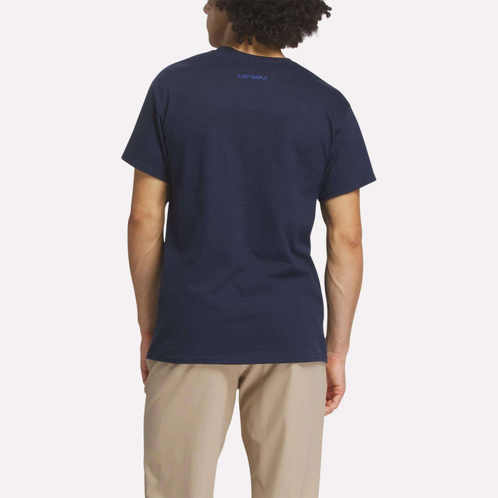 A person with curly hair is shown from the back, wearing a navy blue Reebok Men's Crushers Icon Tee and light beige pants, standing against a plain light background.