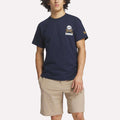A man wearing a blue Men's Crushers Stacked Logo Tee by Reebok.