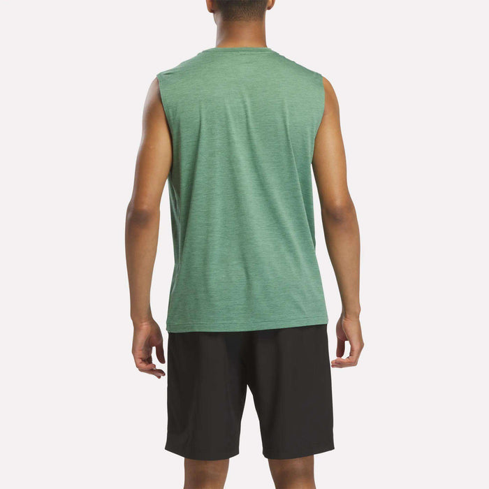 A person is standing with their back to the camera, wearing a green Reebok Men's Elite Sleeveless Top and black shorts, set against a plain white background.