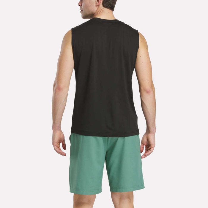 A man faces away, wearing the Reebok Men's Elite Sleeveless Top and teal cotton flex knit shorts, set against a plain white background.