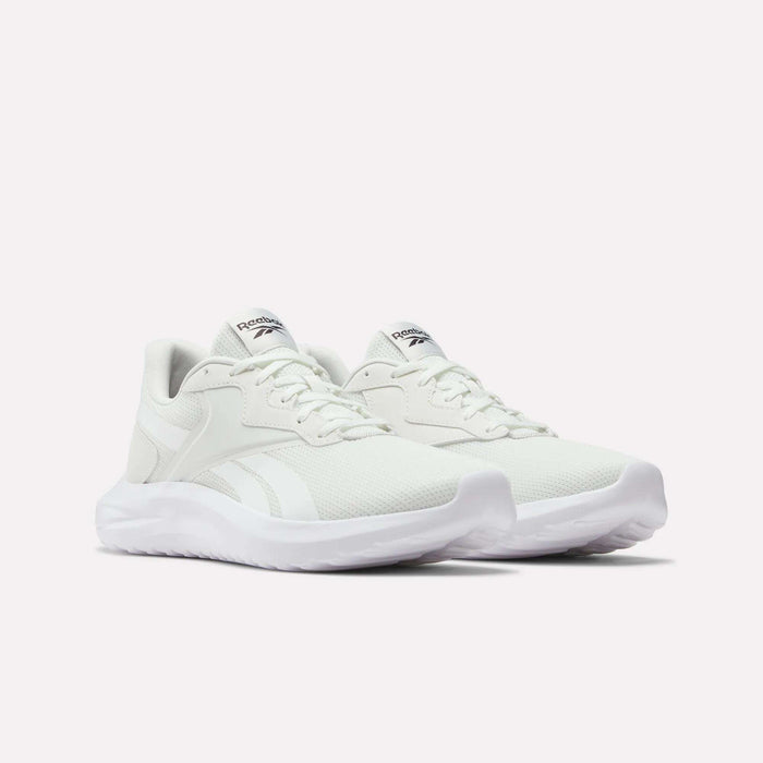 The Reebok Men's Energen Lux Running Shoes feature white mesh uppers, lace closures, and thick textured soles—versatile and perfect for everyday wear. Shown against a plain white background.