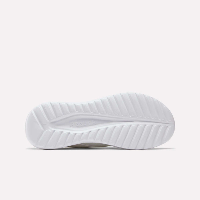 The image displays the white rubber outsole of Reebok Men's Energen Lux Running Shoes, with a wavy, textured pattern for traction. The Reebok logo is subtly featured in the center, set against a plain light background.