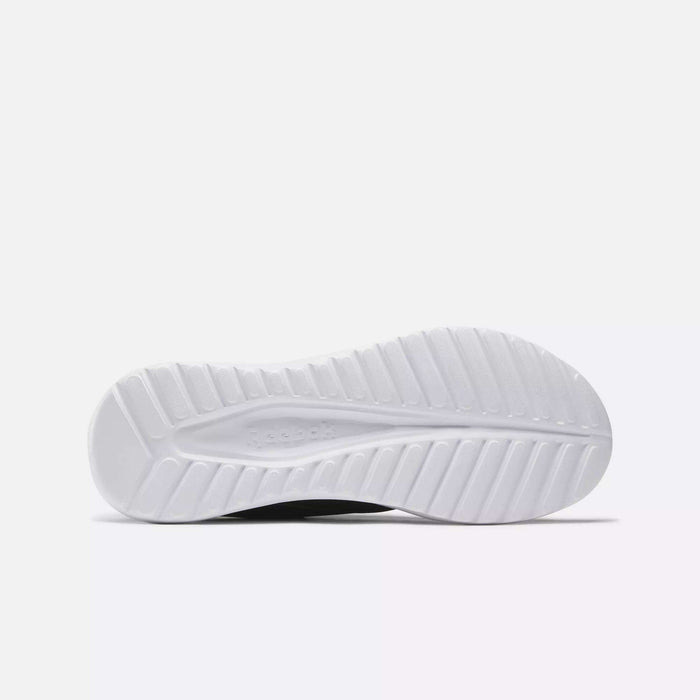 The image shows the white, textured outsole of the Reebok Men's Energen Lux Running Shoes lying flat, with the tread pattern and embossed Reebok logo visible against a plain light gray background.