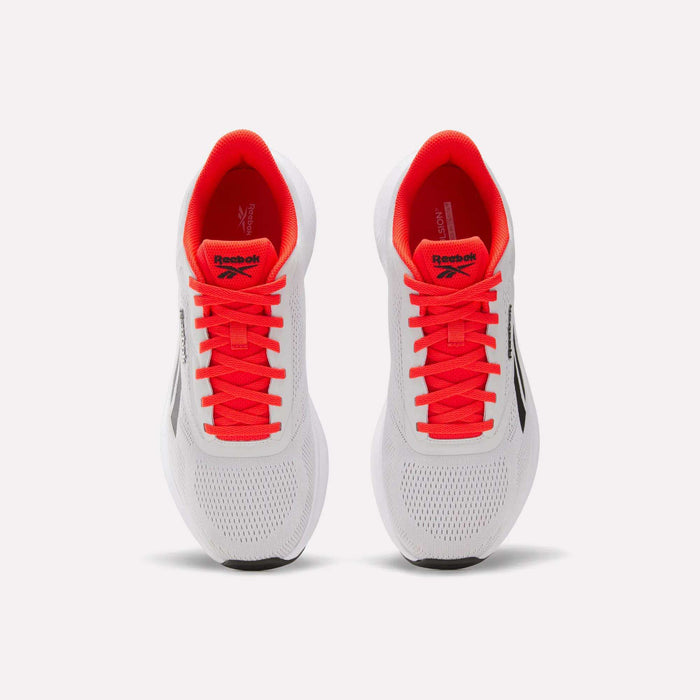 A pair of Reebok Men's Energen Run 4 running shoes in white with black logos, bright red laces, and a breathable mesh upper, viewed from above against a plain light background.