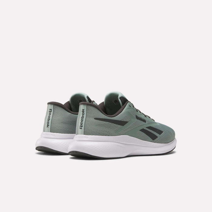 A pair of Men's Energen Run 4 Running Shoes by Reebok in green with black accents and white soles, featuring a lightweight design and breathable mesh upper, are shown on a light background at an angle to display side and back details.