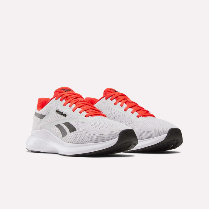 A pair of Reebok Men's Energen Run 4 Running Shoes in white with black accents, red laces, and red lining, featuring a FuelFoam midsole for comfort and support, shown on a plain white background.