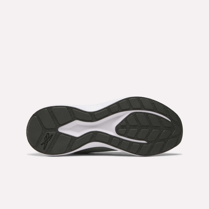 The image displays the black rubber outsole of the Reebok Men's Energen Run 4 Running Shoes, featuring a grip tread pattern and visible logo near the heel. Designed for lightweight comfort, it complements a mesh upper and FuelFoam midsole. Background is plain white.
