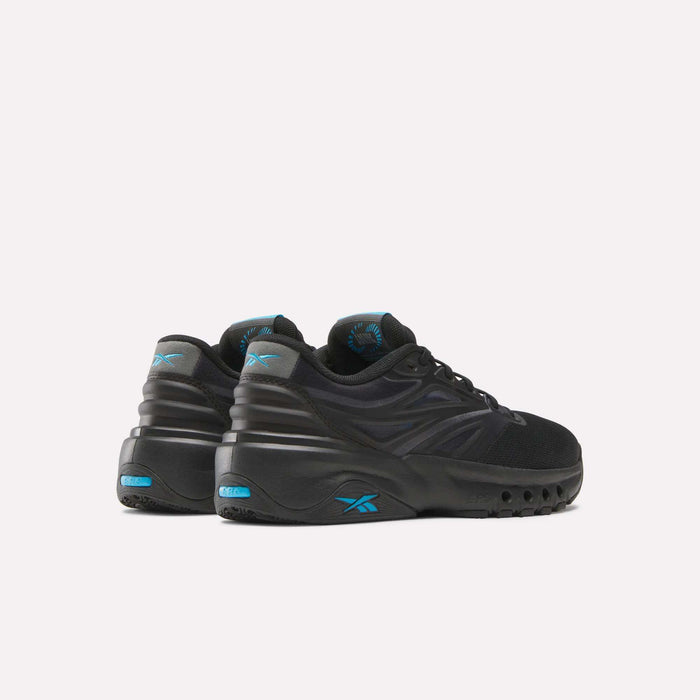 A pair of Reebok Men's ERS Training Shoes in black with blue accents and chunky soles, featuring premium cushioning. Displayed on a light background, the heels face forward and are slightly turned to the right.